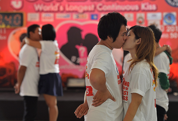 24 hours: Pattaya, Thailand: Couples kiss during a competition