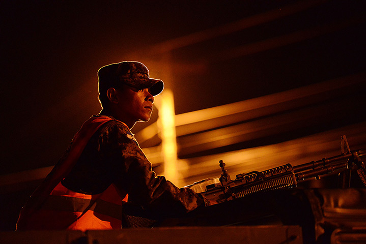 24 hours: Tegucigalpa, Honduras: Soldiers man a checkpoint 