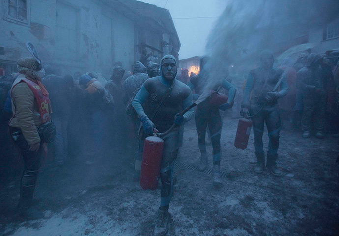 24 hours: Laza, Spain: Revellers use fire extinguishers during a flour fight