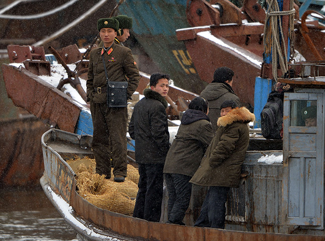 24 hours: Sinuiju, North Korea: Soldiers stand guard along the Yalu River 