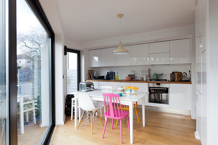 Homes - Lewisham NB: kitchen in narrow house with white walls and wooden floors