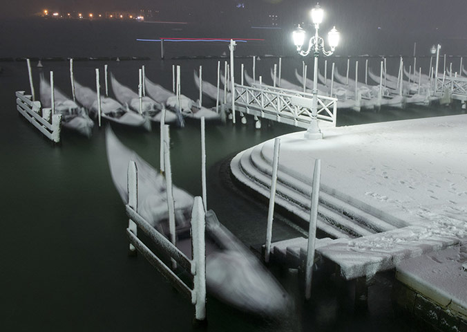 Venice in the snow: Gondolas are covered with snow 