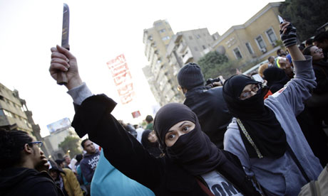 Egyptian woman protester holds up a knife