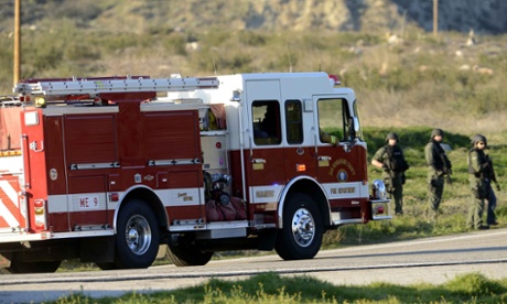 A fire truck passes through a police road block on Highway 38 into the Big Bear area after a shoot-out with suspected fugitive Christopher Dorner.