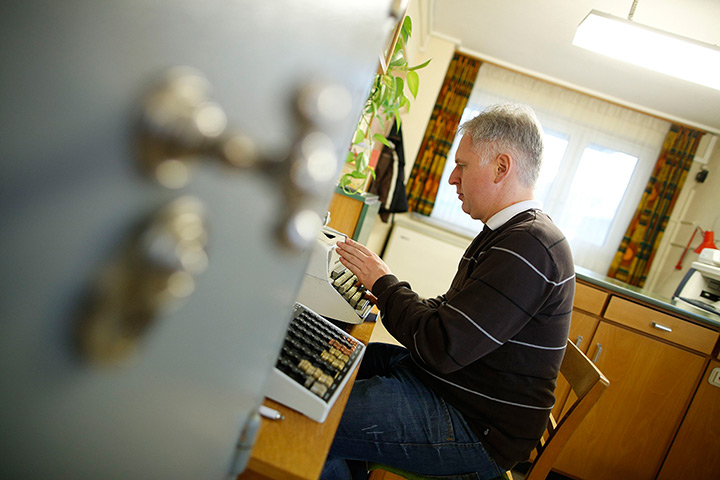 Germany's smallest bank: Peter Breiter uses a typewriter