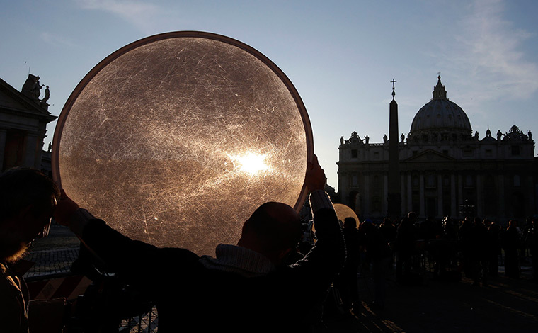 24 hours: Rome, Italy: A lighting technician holds a reflecting panel