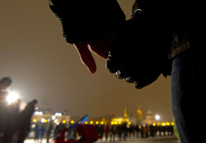 24 hours: Dresden, Germany: People hold hands as thousands create a human chain