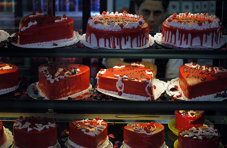 24 hours: Gaza City: A shopkeeper prepares heart- shaped cakes on Valentine's Day