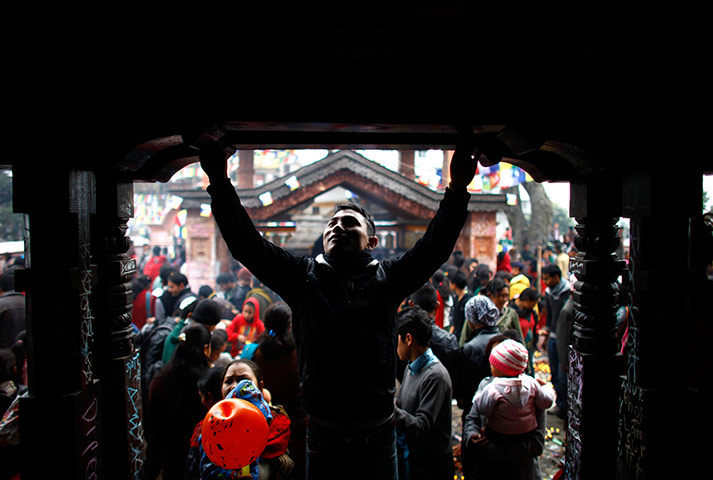 24 Hours: Katmandu, Nepal: Nepalese devotees write with chalk during an annual ritual