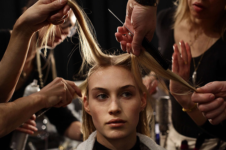 20 Photos: In New York, a model has her hair styled before the Kaufmanfranco show