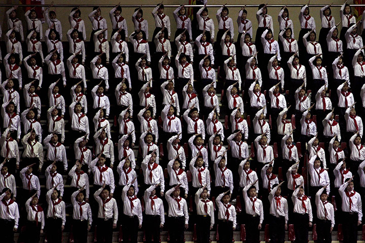 24 Hours: Rows of North Korean children stand and salute at a sports arena