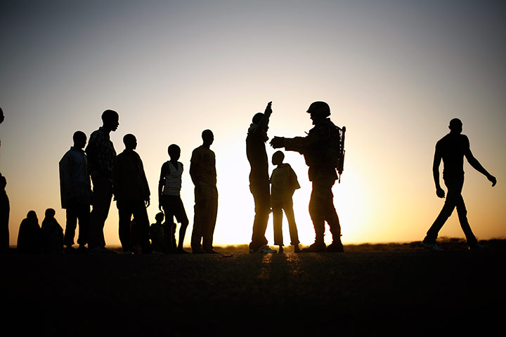 24 Hours: A French soldier checks the passengers from a transport truck in Gao, Mali
