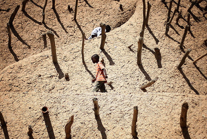24 Hours: Children walk on the Askia mausoleum in Gao, Mali