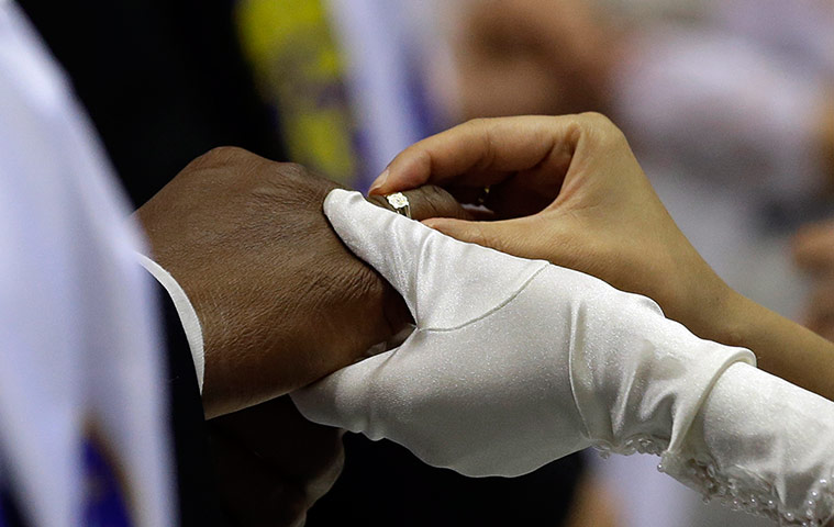 Guardian Camera Club: Patrick Sweeting from Bahama, left, exchanges wedding rings