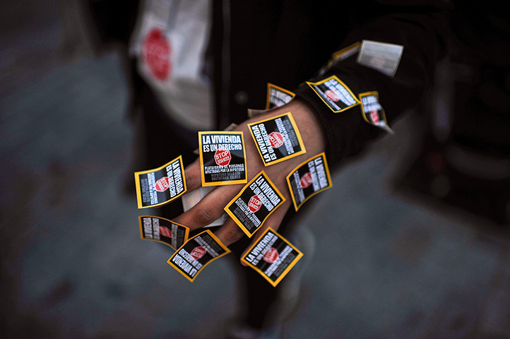 24 hours: Pamplona, Spain: A hand of a demonstrator covered in stickers