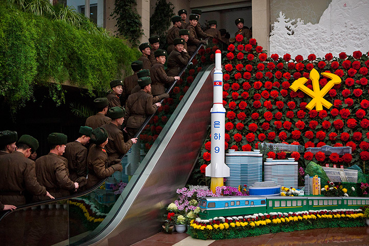 24 hours: Pyongyang, North Korea: Soldiers ride an escalator 