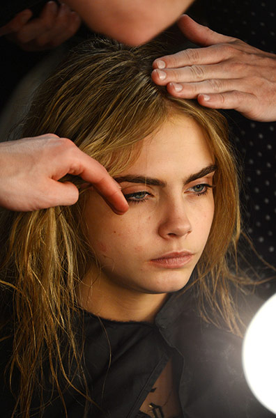 London Fashion Week: Cara Delevingne gets her hair and make-up done before the Topshop show