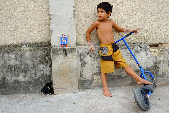 24 hours: Rio de Janeiro, Brazil: A boy plays with scooter in the Cidade de Deus