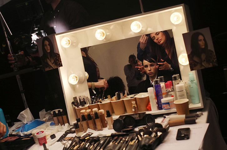 London Fashion Week: A model gets her hair and make-up done backstage before the Burberry show