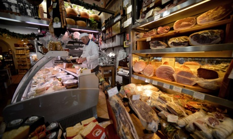 A man works in his grocery shop in downtown Rome. The future of Italy's economy and the social costs of austerity have taken centre stage as Italians prepare to go to the polls next week.