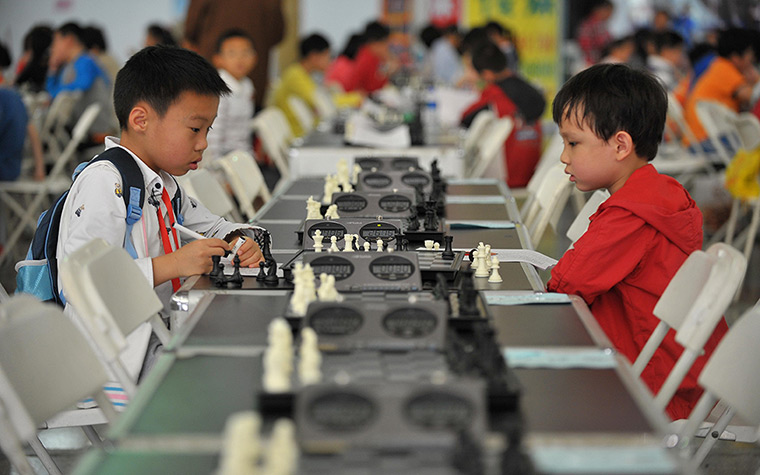 24 hours in pictures: Contestants play in a national chess competition held in Haikou