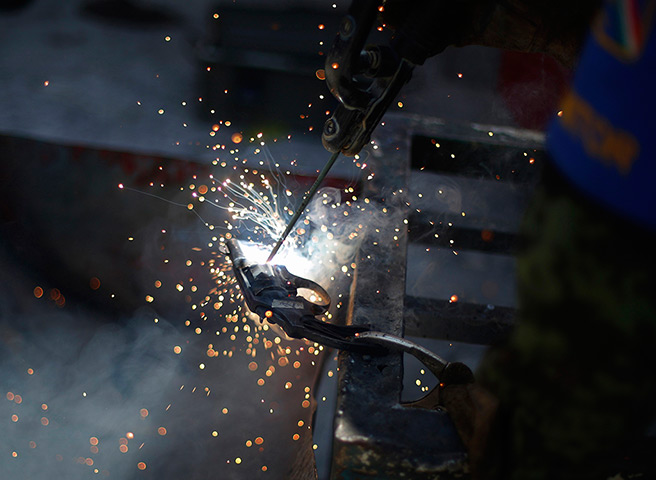 24 hours in pictures: A soldier uses a welding torch to destroy a gun