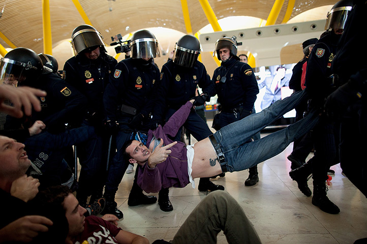 24 hours in pictures: An Iberia airline worker is carried away Spanish riot police