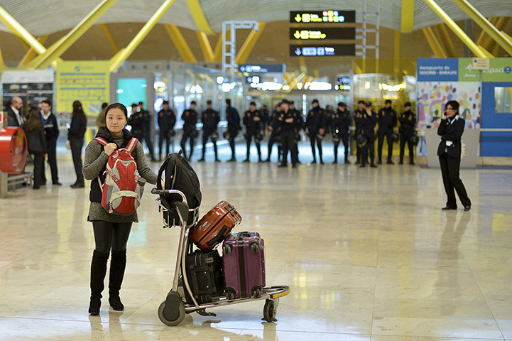 Iberia strike: Day two: A passenger stands near her luggage at Madrid's Barajas airport
