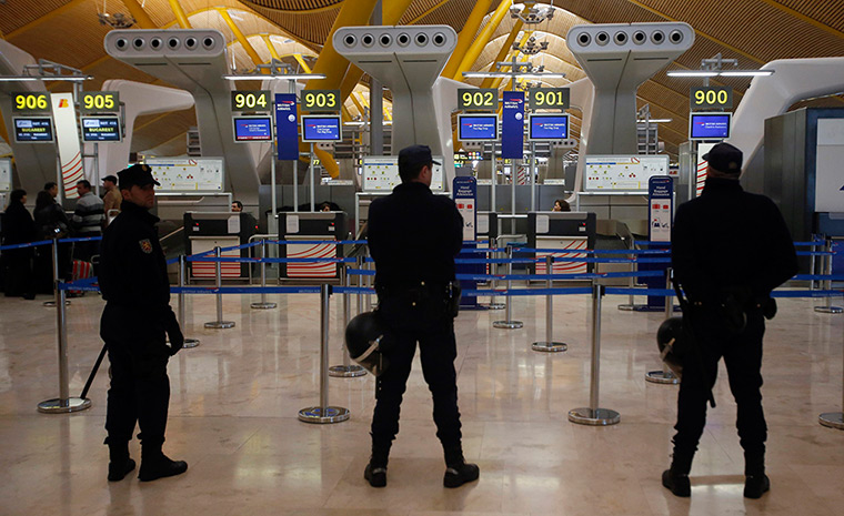 Iberia strike: Day two: Riot police officers stand guard at the BA check-in area 