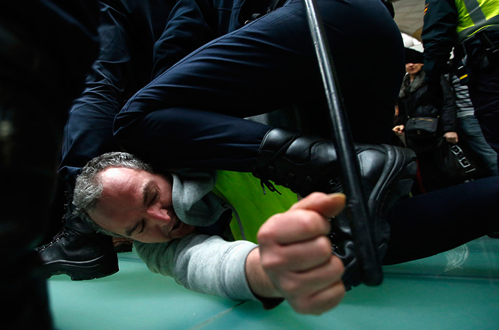 Iberia strike: An Iberia worker is arrested by Spanish riot police