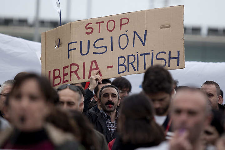 Iberia strike: A man holds a placard against the merger