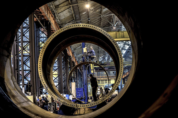 24 hours: mployees assemble pieces of a mast of a wind turbine