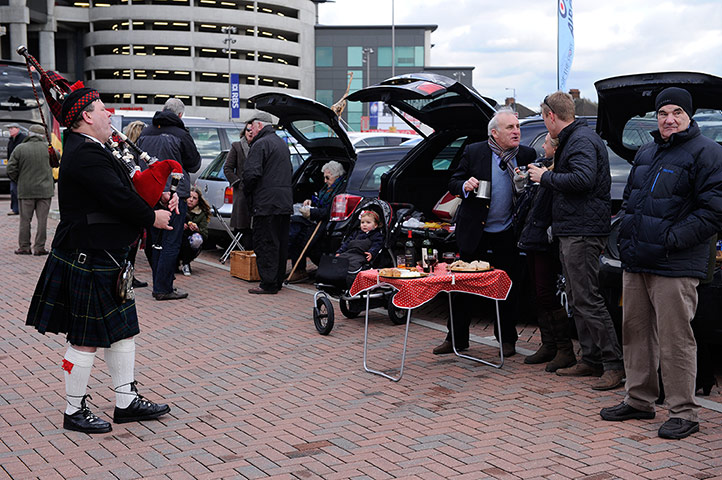 England v Scotland: A piper plays to some picnickers in the west car park