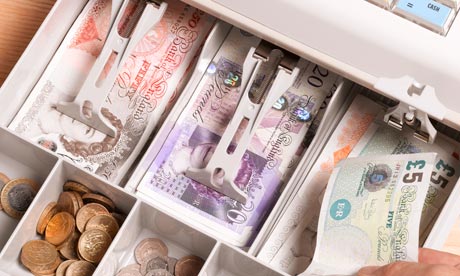 person putting cash in till