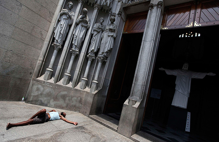 24 hours: Sao Paulo, Brazil: A homeless man sleeps at the entrance of the cathedral 
