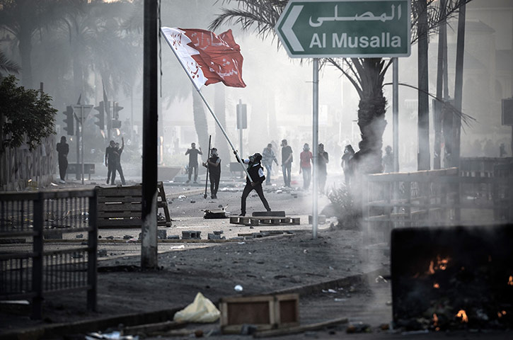 20 Photos: A Bahraini protester waves a giant natio
