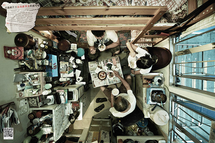 hong kong flats: A group of people eating in their cramped flat.