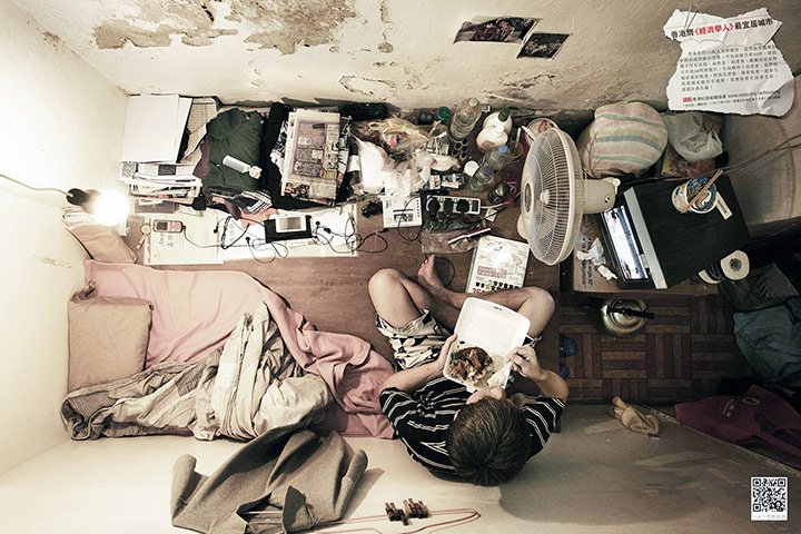 hong kong flats: A man eats dinner in his flat.