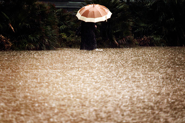 Athens flooding: Woman wading