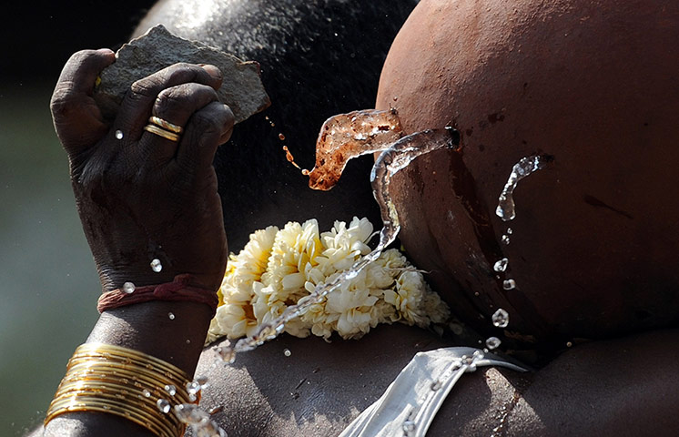 24 hours: A relative uses a stone to break a pot of water
