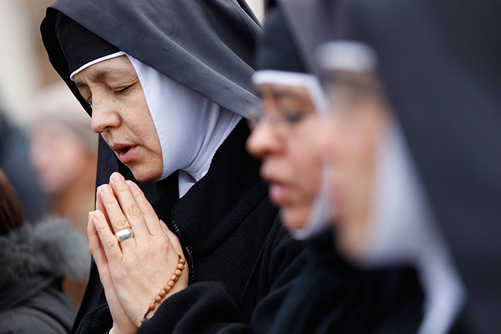 24 hours in pictures: Nuns pray while waiting for Pope Benedict XVI's last Angelus prayer