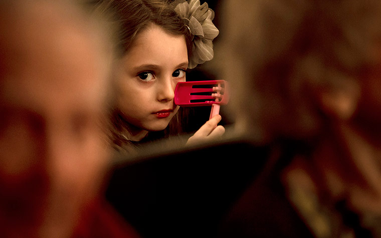 Purim gallery: Sara holds a Purim noisemaker