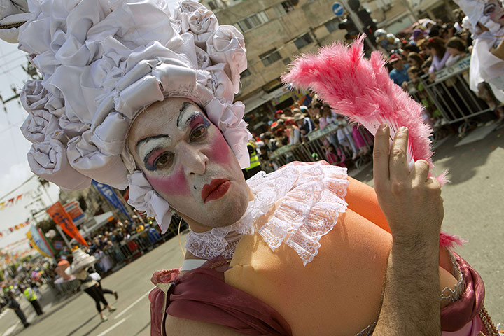 Purim gallery: An Israeli man takes part in a parade to