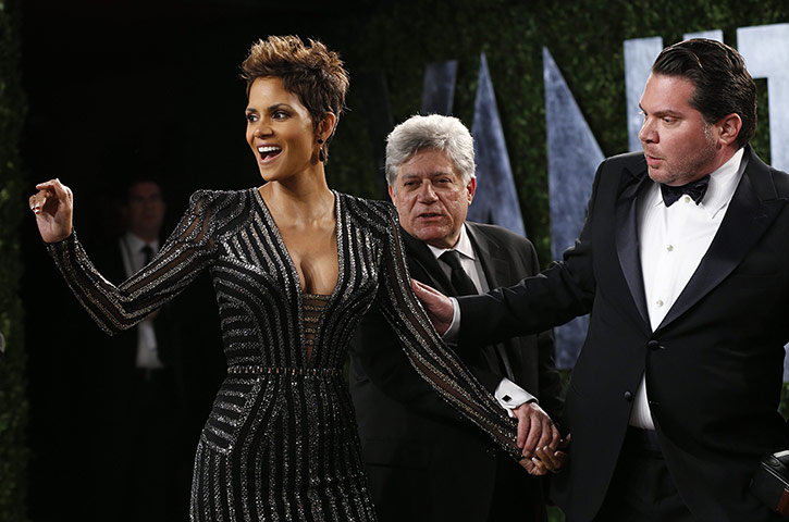 Oscars after party: Halle Berry is guided to her position in front of the cameras