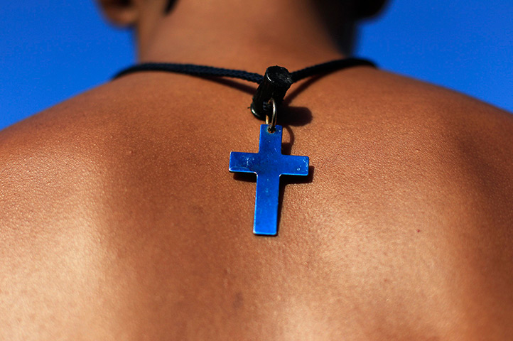 24 hours: La Libertad, El Salvador: A lifeguard wears a cross necklace