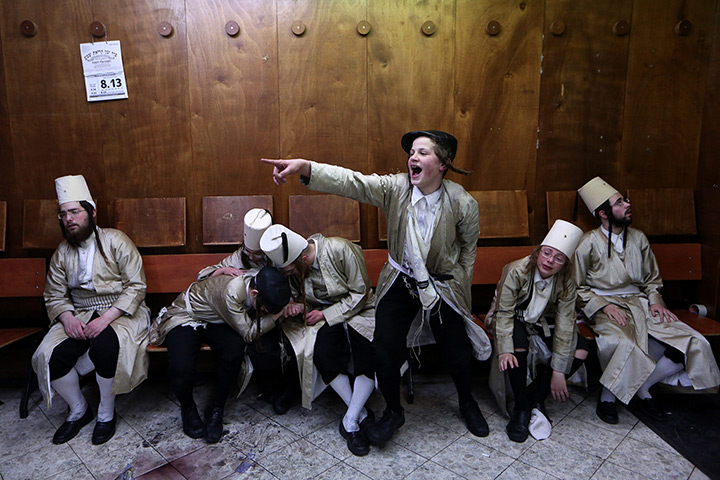 24hours in pictures: ultra-Orthodox Jewish men in costumes revel in a synagogue