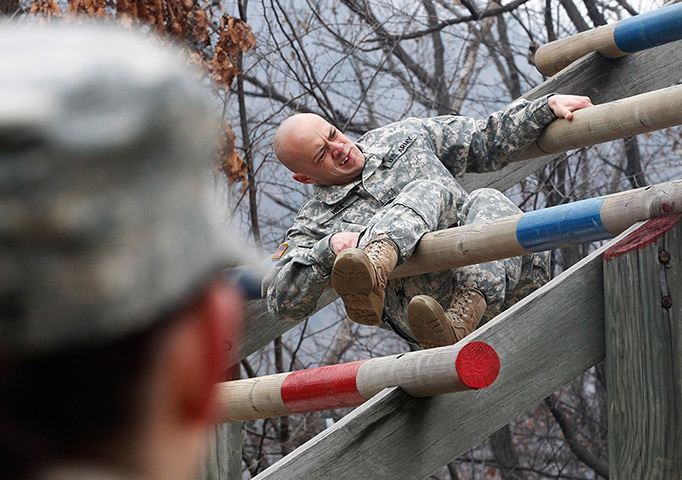 24hours in pictures: A US Army soldier negotiate an obstacle structure 