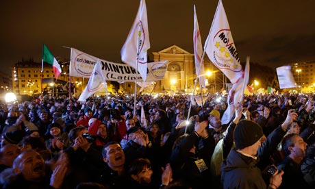 People react as Five Star Movement leader and comedian Beppe Grillo arrive during a rally in Rome