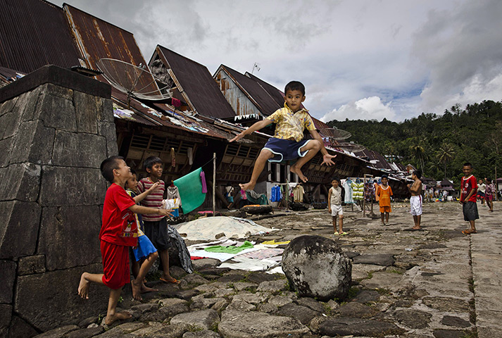 Stone jumping on Nias: Children learn to jump over the stone tower in Orahili Fau village 