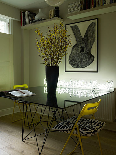 Homes - Economy Class: glass table with flowers and yellow chair